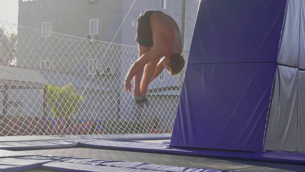 A pro jumps on a trampoline