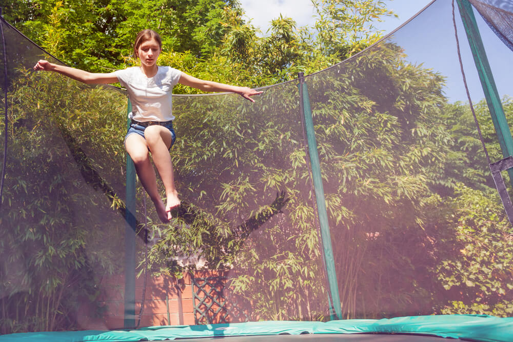 woman jumping on Trampoline with safety net