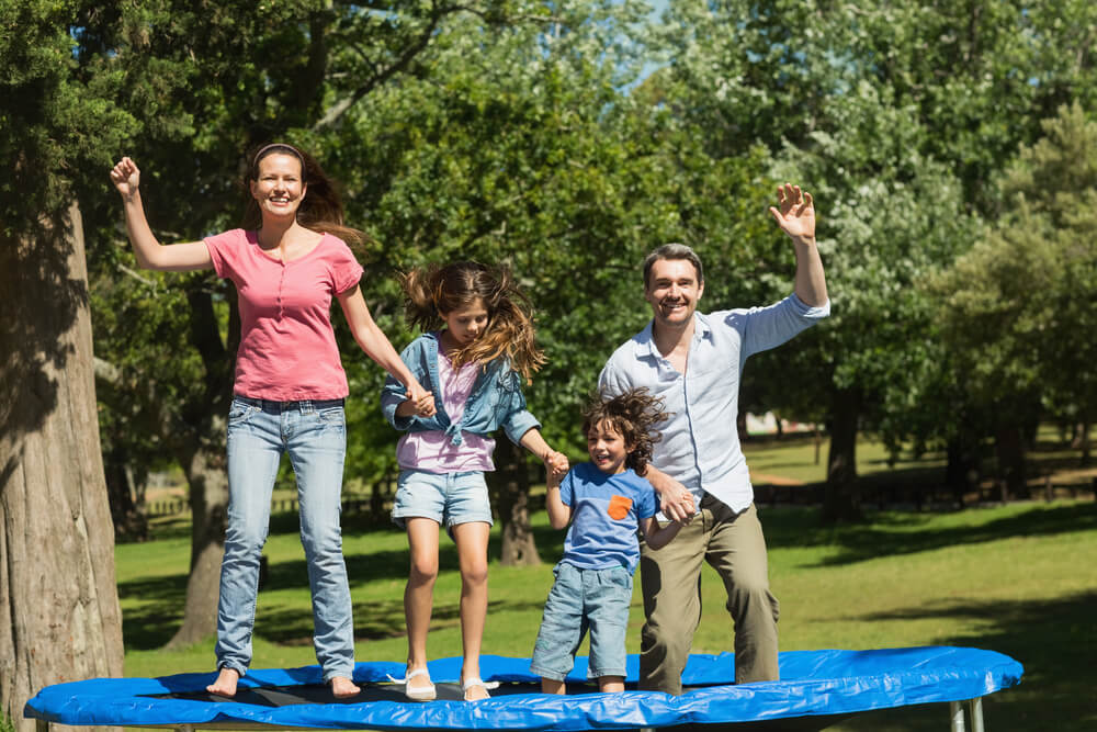 Family jumping on a trampoline