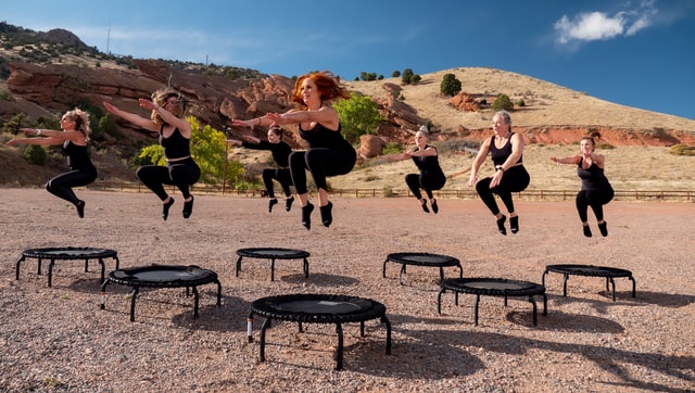 A group of girls training on trampolines
